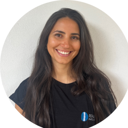 Sara Cloros, physiotherapist at Realign Physio & Co, smiling in a black shirt with the clinic logo, promoting personalised physiotherapy services.
